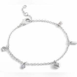Coach New NWT silver tone chain charm bracelet featuring multiple charms